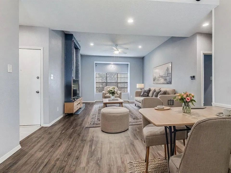Living room and dining room shown with virtual AI staging.
