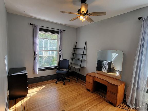 Bedroom with light, overlooking street.