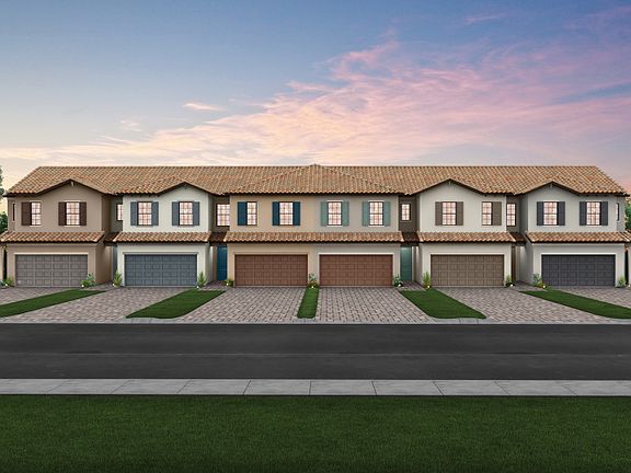 The Adirondack, a two-story town home with a 2 car garage, shown with Home Exterior C2A-B 6-unit VE