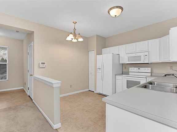 View of entry and kitchen. Garage entry to home is on right of entry.
