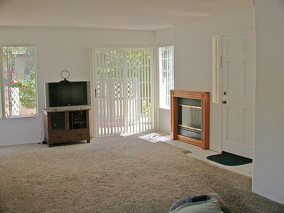 living room opens to patio, has gas log fireplace