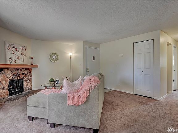 Wood burning fireplace in living room.