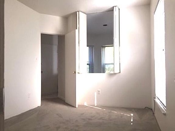 upper level, bedroom overlooking lower level living area