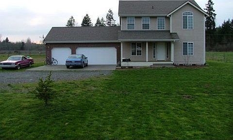 view with 3 car garage, huge front yard