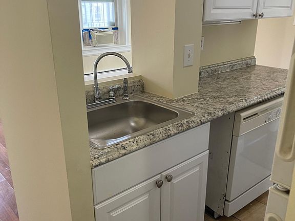Kitchen with new cabinets and dishwasher.