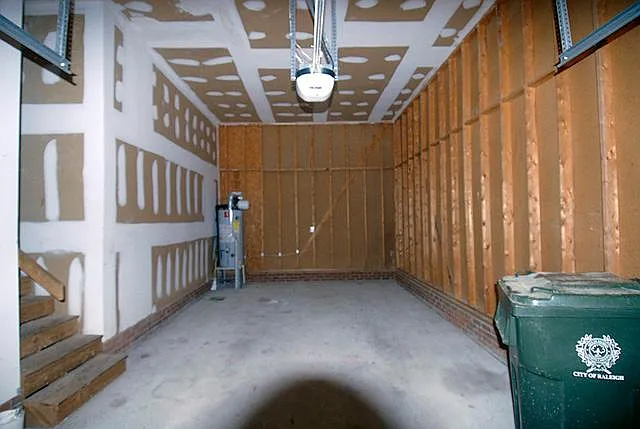 Spacious garage long enough for two compact cars. Garbage service available
