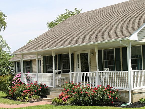View from opposite end of front yard
						:
						Custom landscaping around the house.
