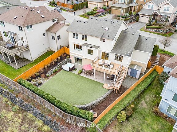 Custom landscaped and curated back yard featuring 2-tier-deck with updated composite decking; glass panels to showcase view from every angle; no-to-low-maintenance field turf hot-tub spa, rock wall and 5 entraining and leisure areas.
