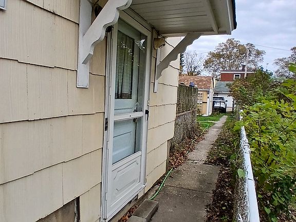 Tenant entrance with motion-sensitive security light by door.