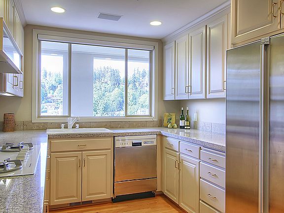 Cook's kitchen with granite counters, gas cooktop and stainless appliances.