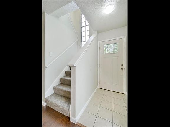 Bright front entry hall has tile floor.