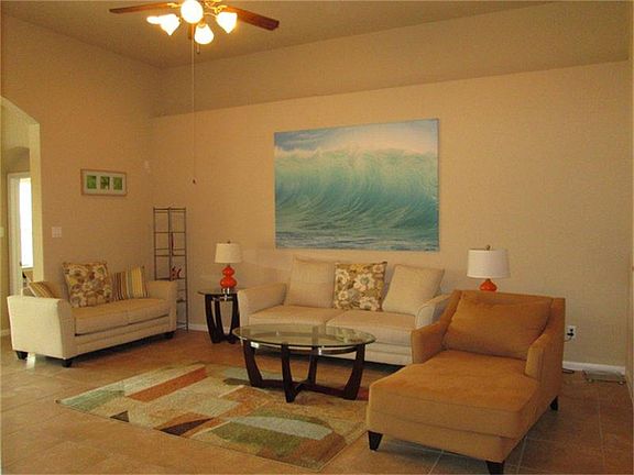 Light and bright family room with tile floor and art niches