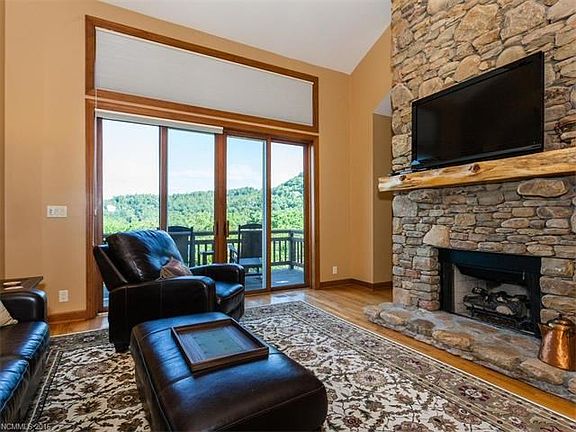 Beautiful 20 Foot Floor Ceiling Stacked Stone Gas Fireplace - great windows with mountain views