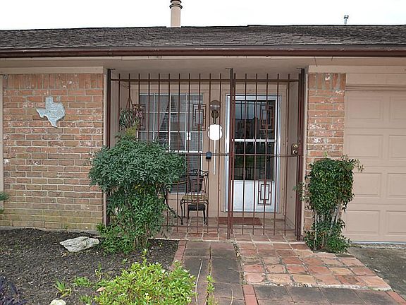 Gated front doorway with a storm door.