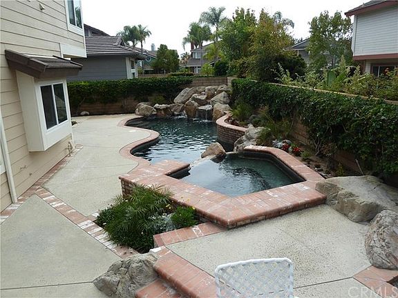 Spa and pool with waterfall and newly landscaped rear yard.
