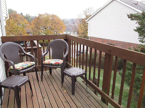 Deck overlooks greenspace.