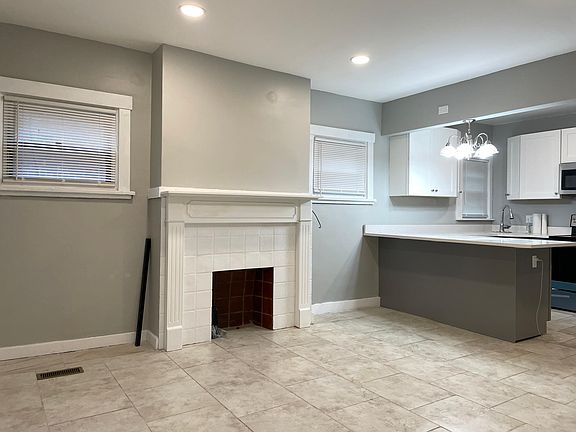 View 1 of the sitting room. Open layout with upgraded new fireplace mantel decoration.