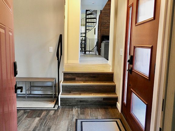 Entryway from garage into foyer. Looking into living room and dining area.