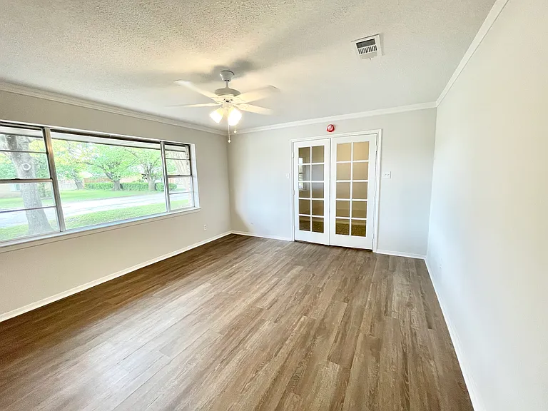 Inside the entry are french doors that can be used for an office, game room, or bedroom.