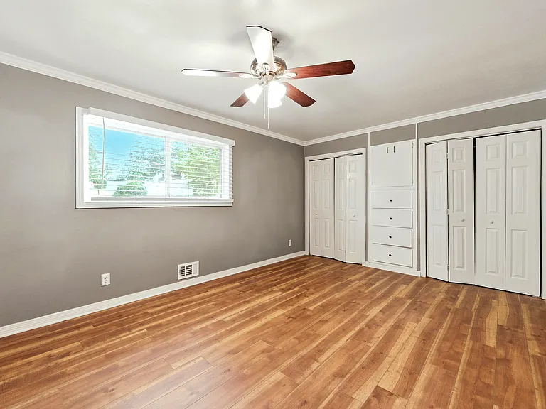Primary Suite contains a ceiling fan for year-round comfort, and abundant closet space with built-in storage.