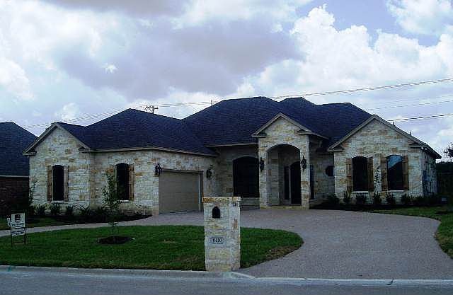 Great curb appeal with chopped stone, shutters and circle drive.