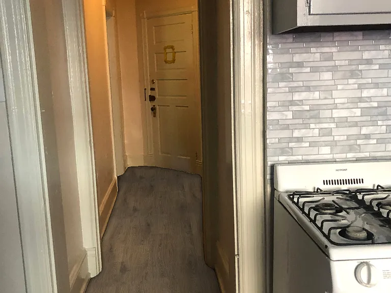 Hall from front door to large eat-in kitchen with dishwasher and two large windows.
