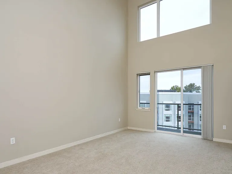 Carpeted Living Room with Balcony
