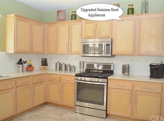 Beautiful, bright kitchen, with stainless steel appliances.