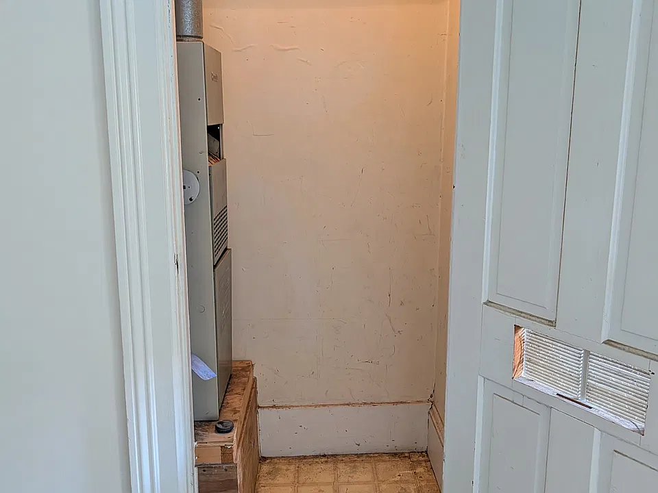 Storage space in living room near front door.