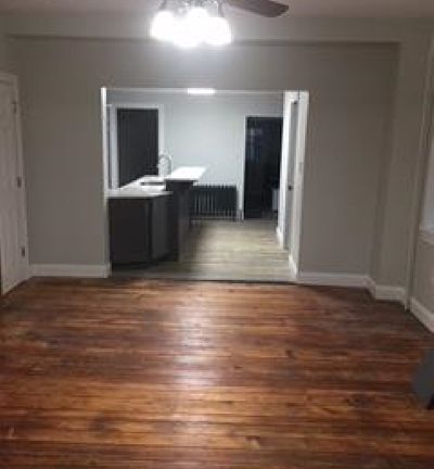 Dining room with view into kitchen. Half bath to the right and mudroom/back entry beyond