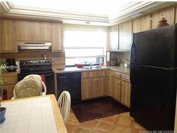 Open kitchen, currently stainless steel refr.