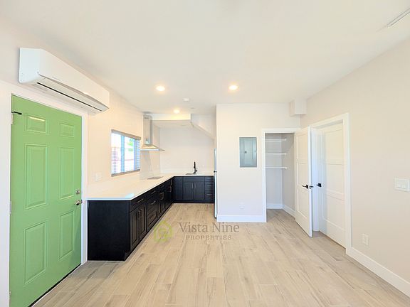 Kitchen with plenty of cabinets, pantry, mini split heater and air conditioner