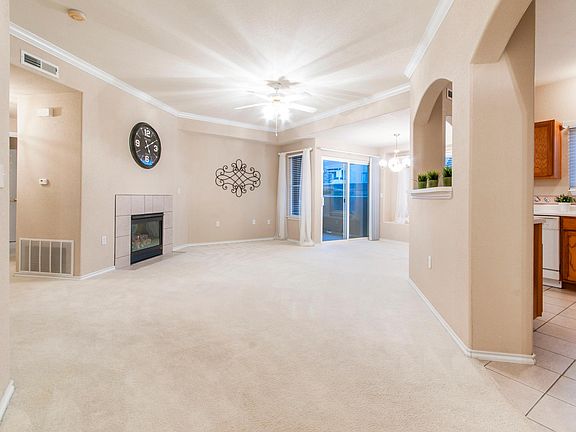 The living room has many windows provide natural light and good air circulation