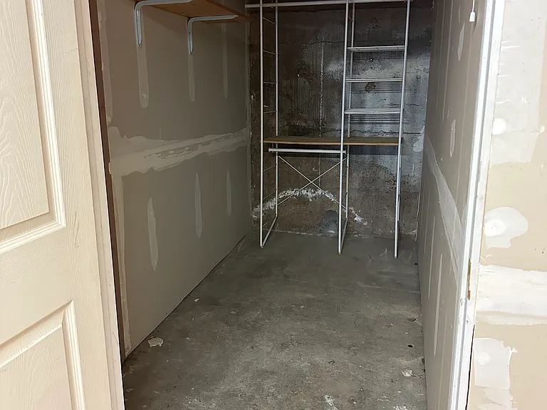 Clean, dry and secure storage unit with built in shelves located in the basement
