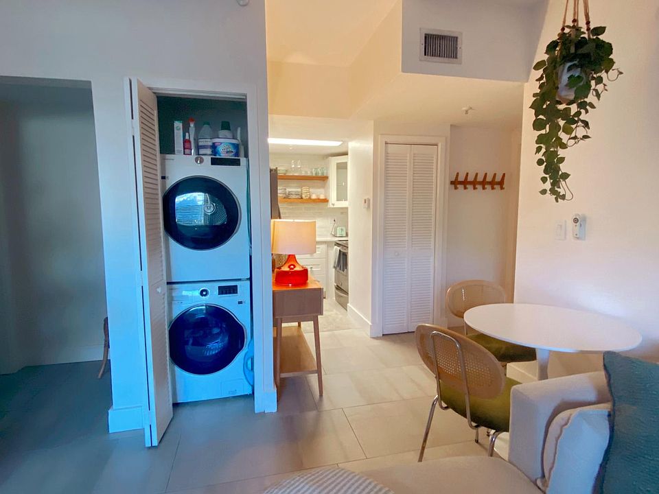 living room with new washer / dryer view