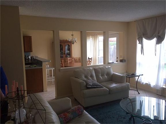 As you enter the Living Room you can look into the Kitchen and informal dining area.