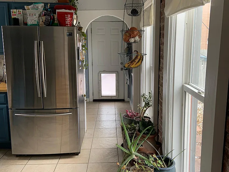 Hallway to back yard door and bathroom to the left.