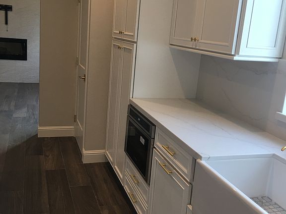 kitchen looking past laundry into living room