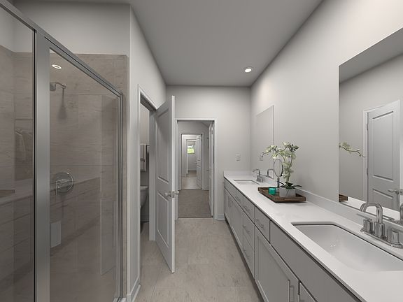 The primary bathroom offers dual vanity sinks and a walk-in shower.