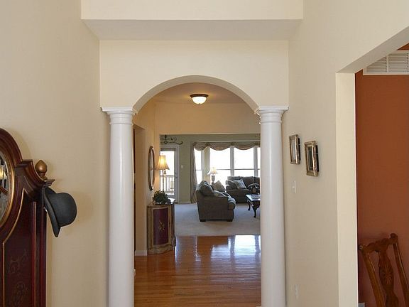 Arched column entry into Family Rm. Balcony overlooking Foyer