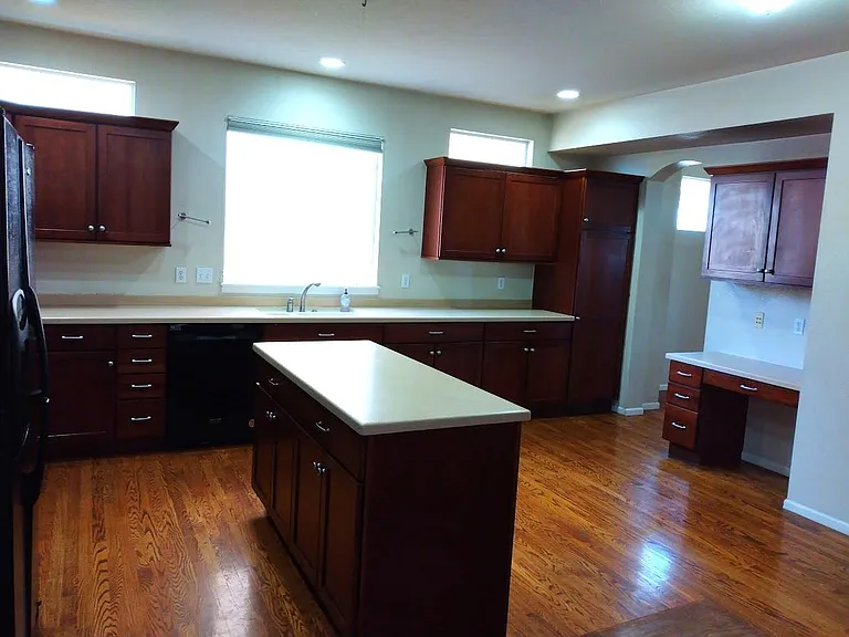 Kitchen with corian countertops and cherry cabinets