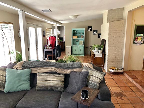 Entryway behind living room with desk as a 2nd office