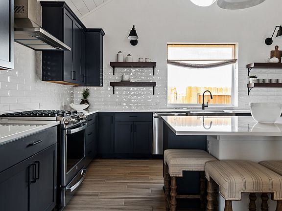 Floating shelves in the kitchen with subway tile backsplash