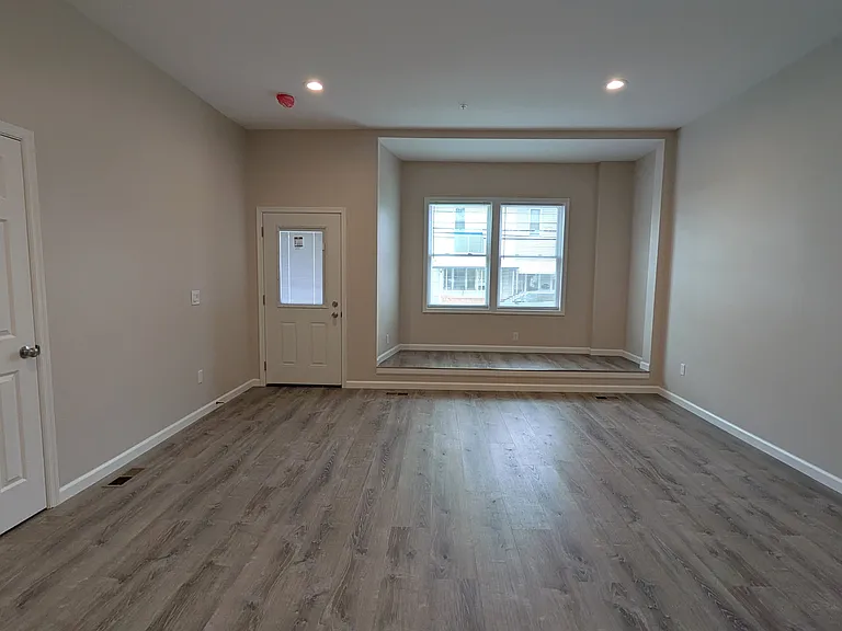 Spacious living room with an architectural alcove that you can watch the world go by from