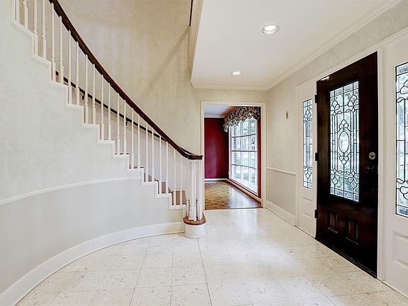 The formal living room and dining room flank the entrance.