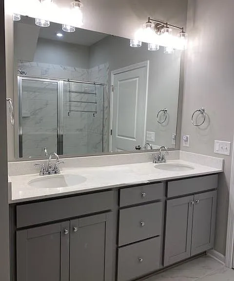 Downstairs master bathroom, double sinks and marble and glass shower.