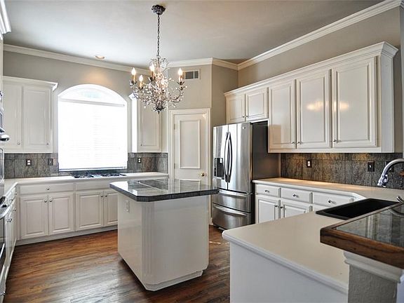 Large kitchen with center island. Lots of cabinets and pantry