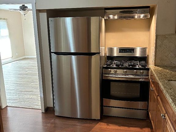 New refrigerator. Gas stove. Hood vent.