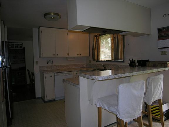 Kitchen with eating bar. All appliances will stay!