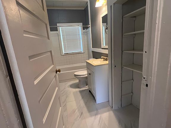 The bathroom was completely remodeled with a new toilet, flooring, and a vanity.